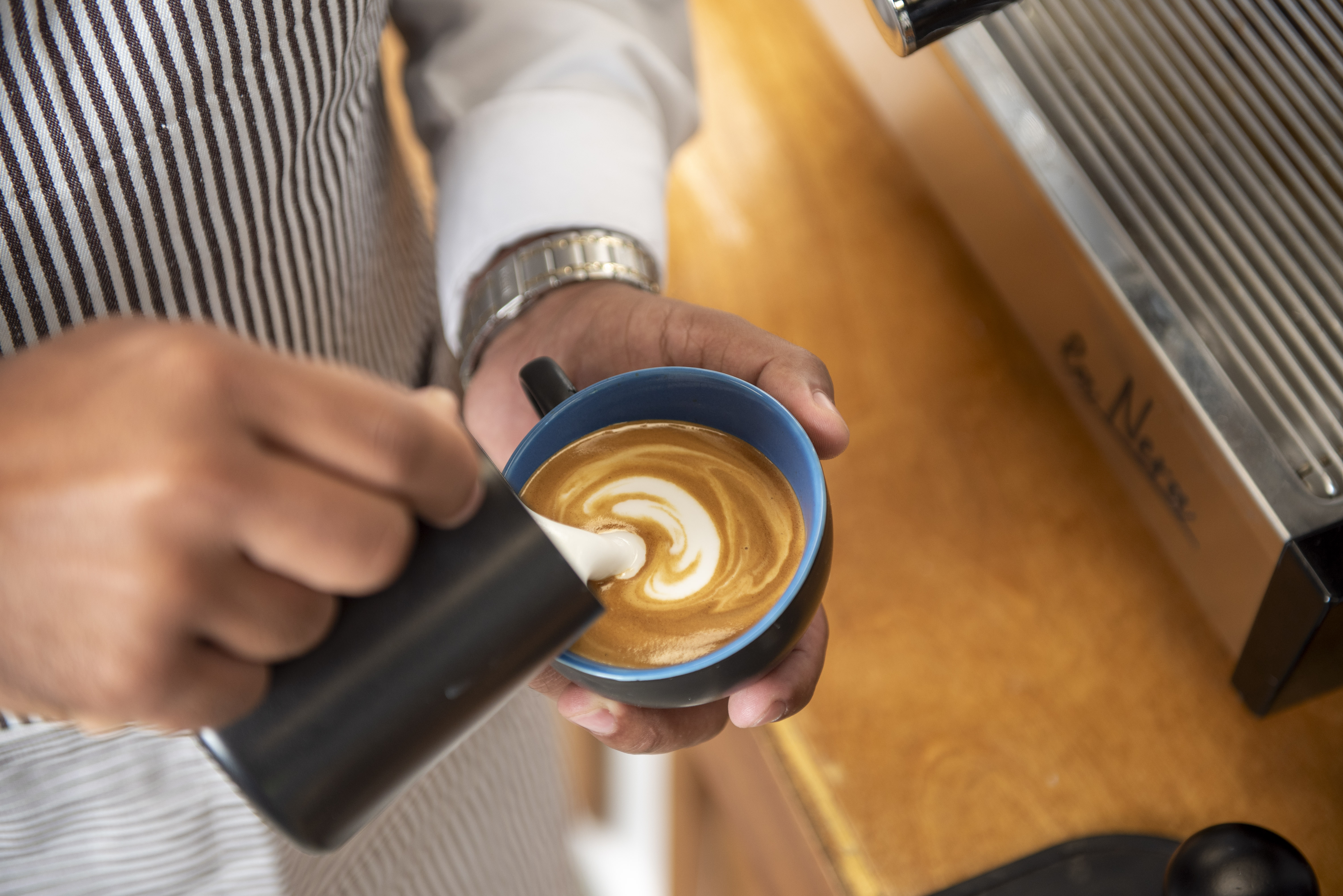 Skilled barista creating exquisite latte art