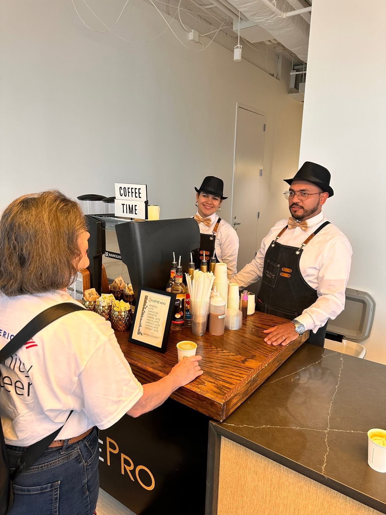 Professional baristas serving coffee at corporate event