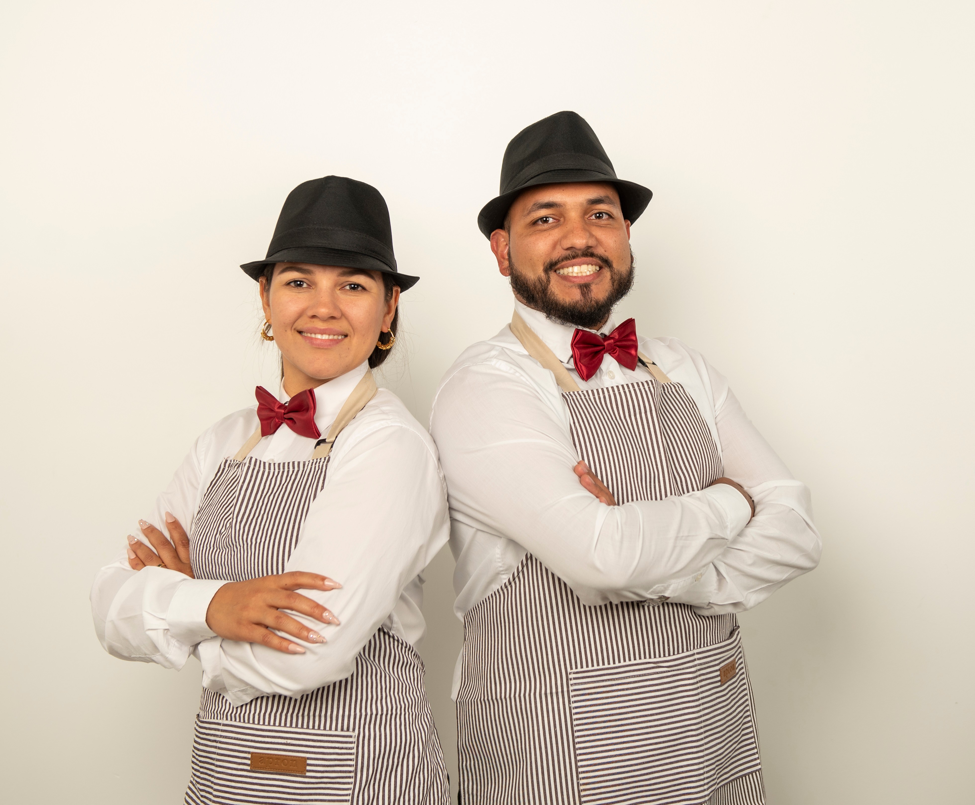 Professional barista couple in elegant uniforms with confident poses