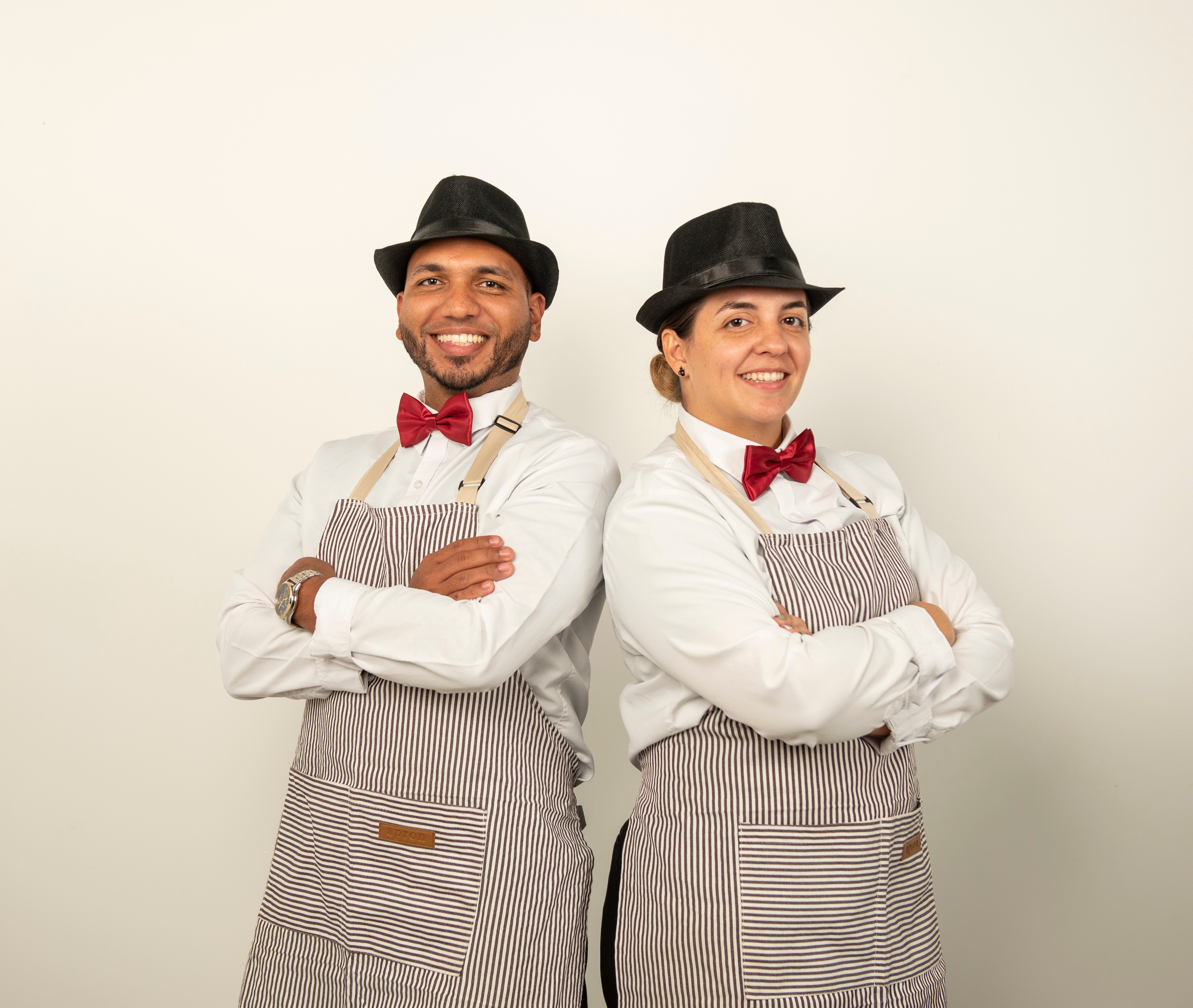 Professional barista duo with crossed arms showing confidence and expertise